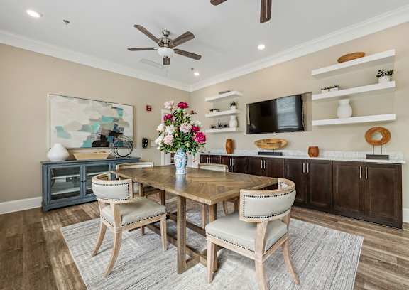 A dining room with a wooden table and chairs.