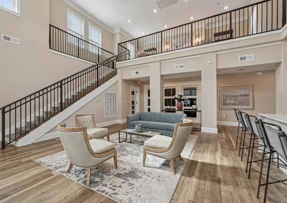 A living room with a staircase and a couch.