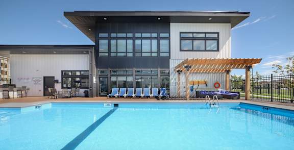 A large swimming pool in front of a modern building.