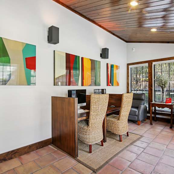 A room with a wooden bar and chairs.