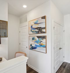 a living room with white walls and two paintings on the wall  at The Meadows, Bloomingdale, Georgia
