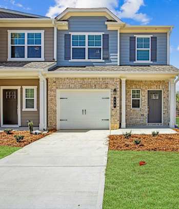 a house with a white garage door and a lawn