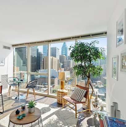 a living room with a large window and a view of the city