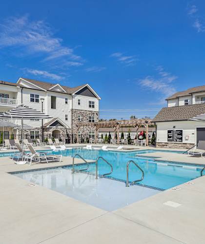 our apartments have a large pool with chairs and umbrellas