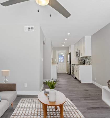 a living room with a couch and a coffee table and a tv