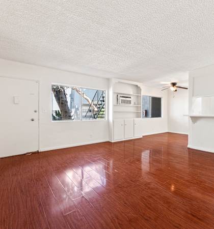 A room with wooden floors and white walls.