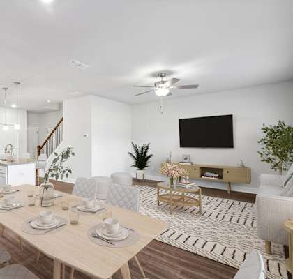 a living room and dining room with a table and chairs