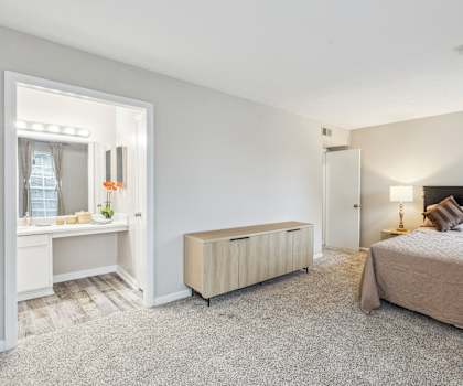 a bedroom with a bed and a desk and a mirror