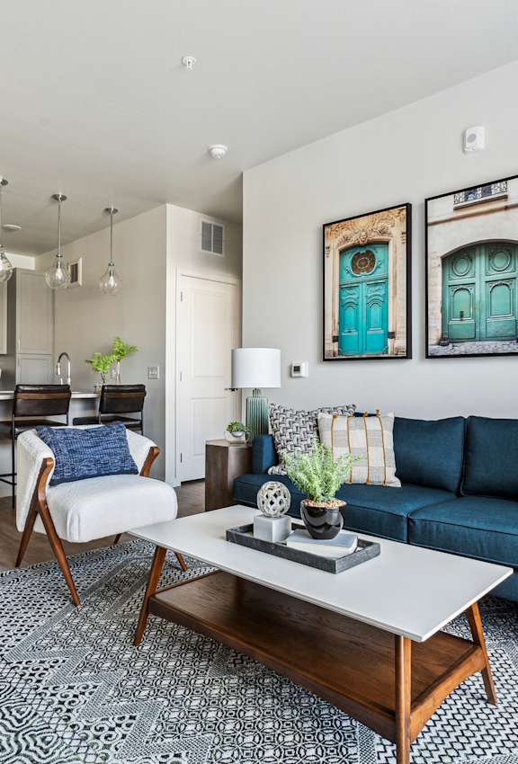 A living room with a blue couch and a coffee table.