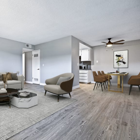 a living room and dining room with gray walls and hardwood floors