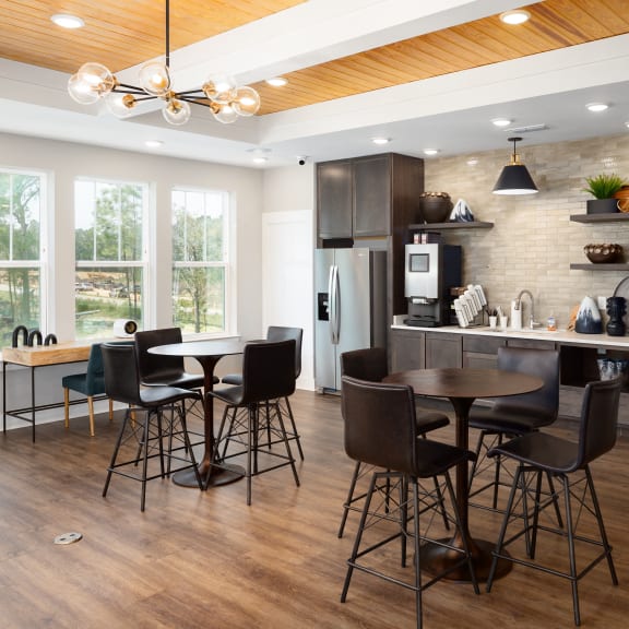 a kitchen and dining room with a table and chairs