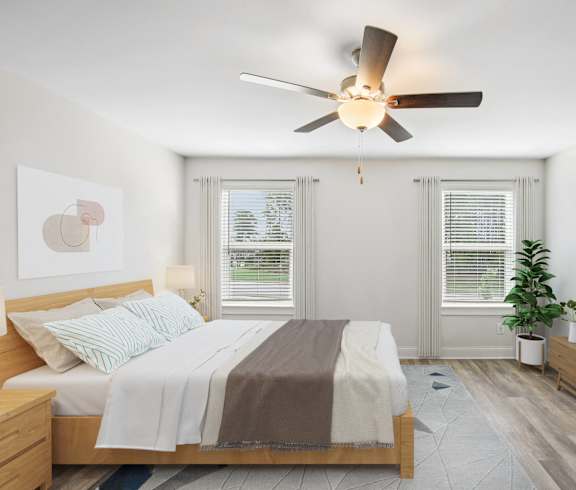 a bedroom with a bed and a ceiling fan