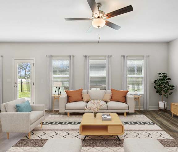 a living room with a couch and a ceiling fan