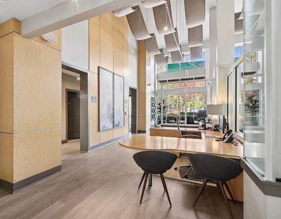 A modern office space with wooden floors and furniture.