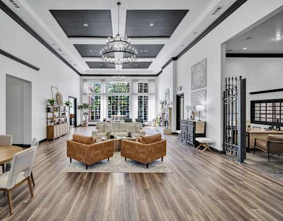 the living room of a new home with furniture and a chandelier