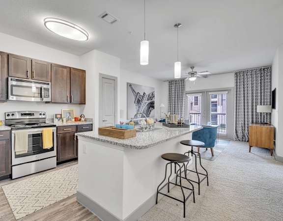 an open kitchen and living room with a large island and stools