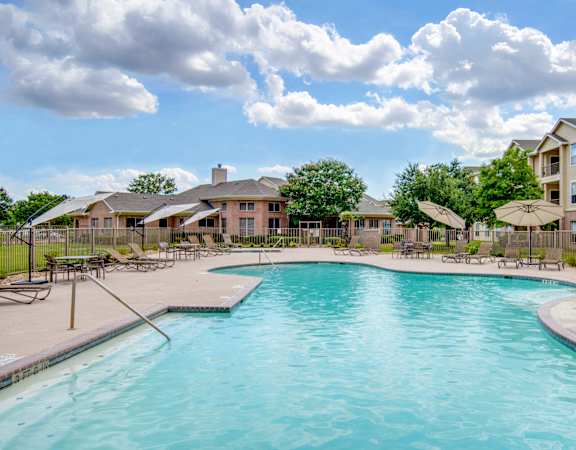 the swimming pool at the preserve at polo ridge apartments in dripping springs tx