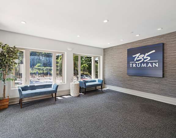 A waiting room with a sign that says 135 Truman.