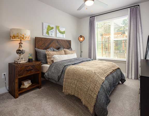 a bedroom with a bed and a large window