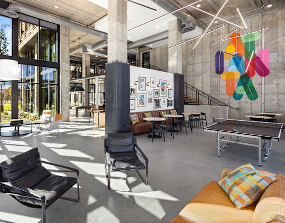 A modern room with a black chair and a table.