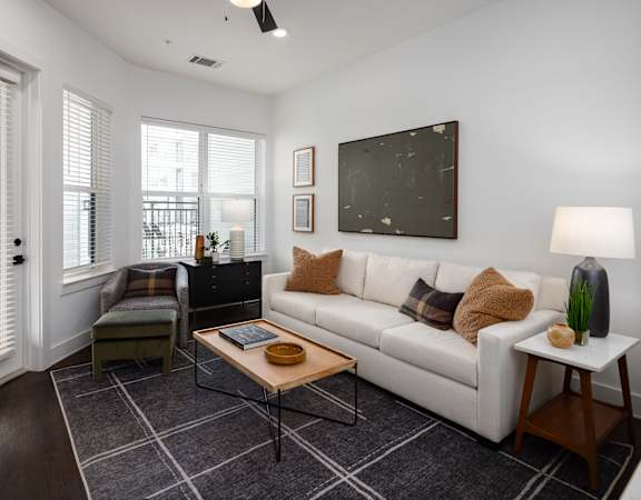 a living room with a white couch and a coffee table