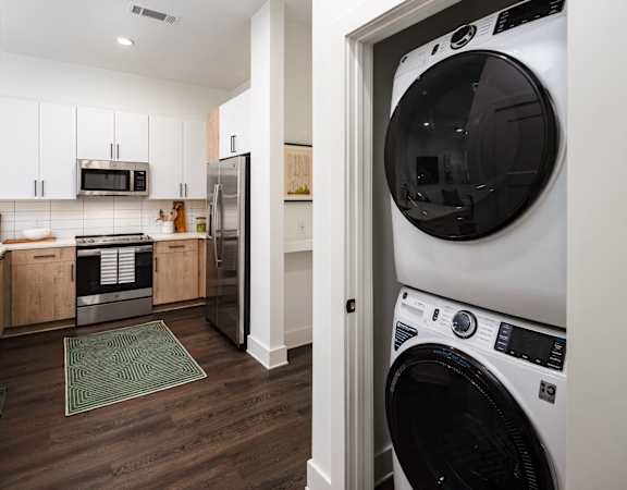 a white laundry room with a washer and a dryer in it