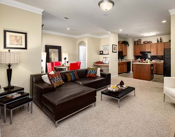 A living room with a brown leather couch and a coffee table.