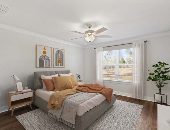 a bedroom with a bed and a ceiling fan