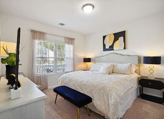 a bedroom with a bed and a dresser and a window