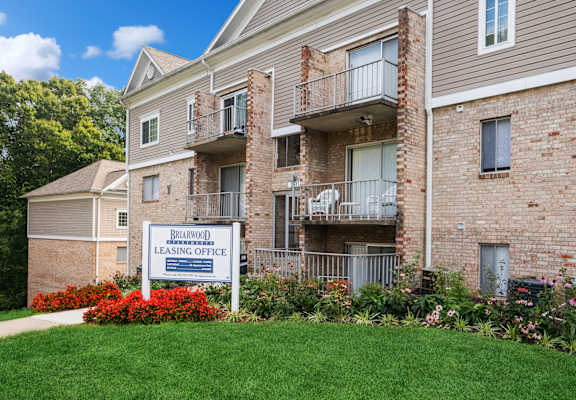 Briarwood exterior with property sign  at Briarwood Apartments, Dumfries, Virginia