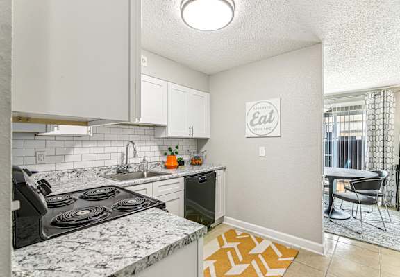 A kitchen with a marble countertop and a sign that says "Eat".
