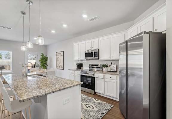 a kitchen with stainless steel appliances and a granite counter top