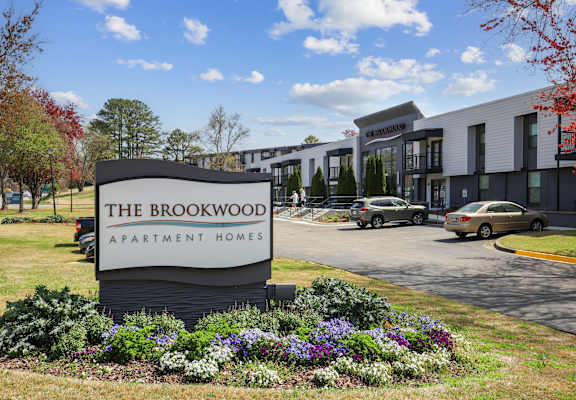 the brookwood apartment homes sign in front of a parking lot