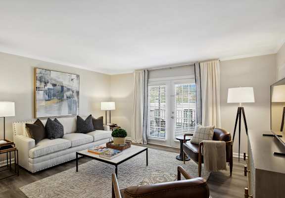 a living room with a couch and a chair and a table