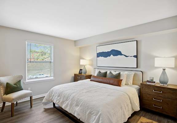 a bedroom with a large bed and a window
