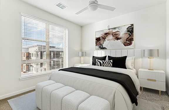 A bedroom with a large bed, a ceiling fan, and a window with blinds.