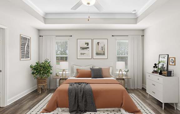 a bedroom with a bed and a ceiling fan