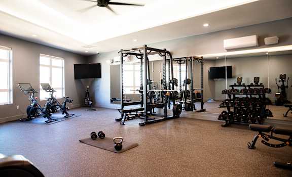 A spacious home gym with a variety of exercise equipment. at The Mill on Maple Apartments, Oregon City, OR 97045