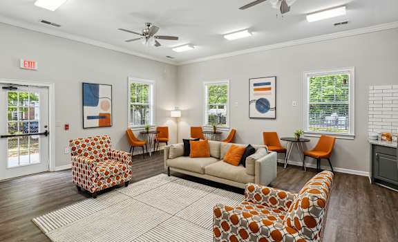 a living room with couches and chairs