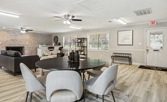 a living room with a table and chairs and a fireplace