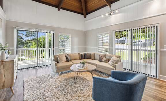 a living room with a couch and chairs and a rug