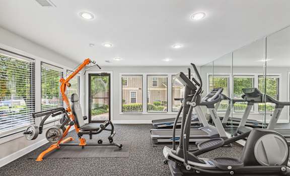 the gym has plenty of exercise equipment and windows at Linden Ridge, Stone Mountain, GA, 30083