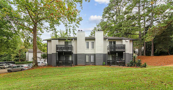 A modern two-story house with a balcony on the second floor.