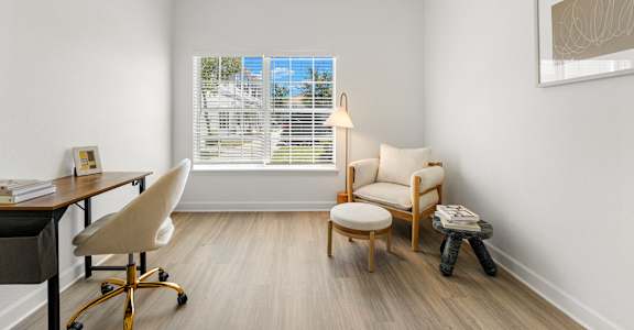Kissimmee, FL Townhomes for Rent - Estates at Lake Cecile –A room with a desk, chair, and window with blinds.
