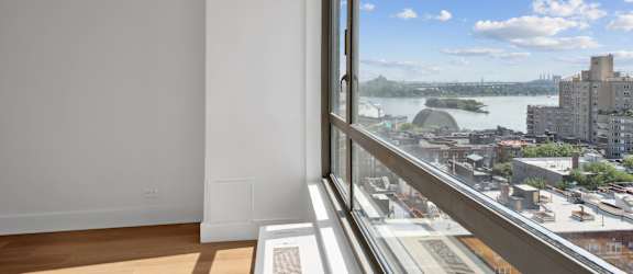A room with a window overlooking a cityscape.