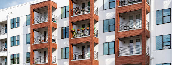 A modern apartment building with balconies and windows.
