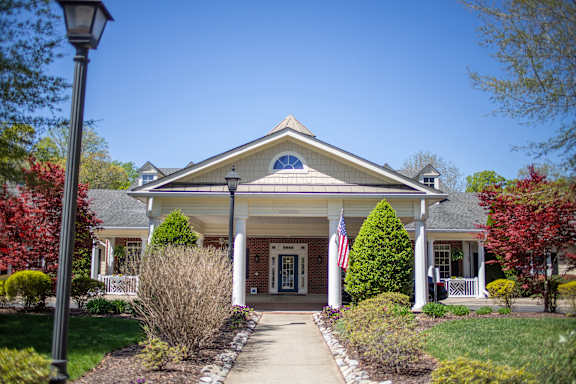 A house with a flag on the front porch.