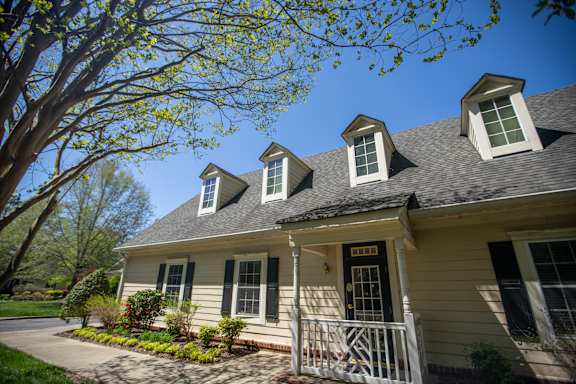 A house with a white porch and a black door.