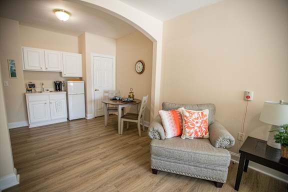 A living room with a grey couch and a wooden table.