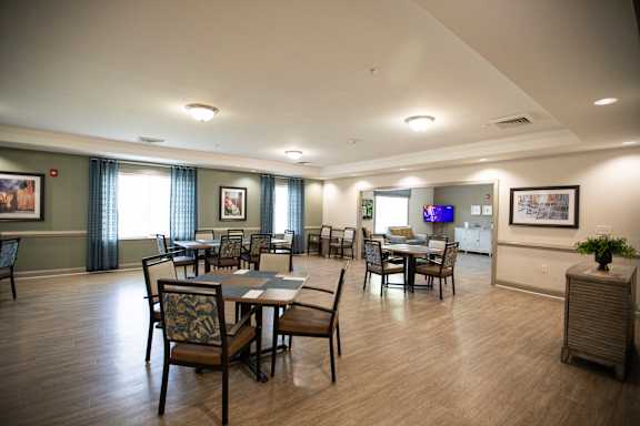 A large room with a dining table and chairs.
